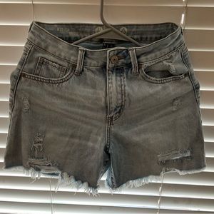 Medium wash high rise denim shorts. Size 1/25. Normal wear, in good condition.